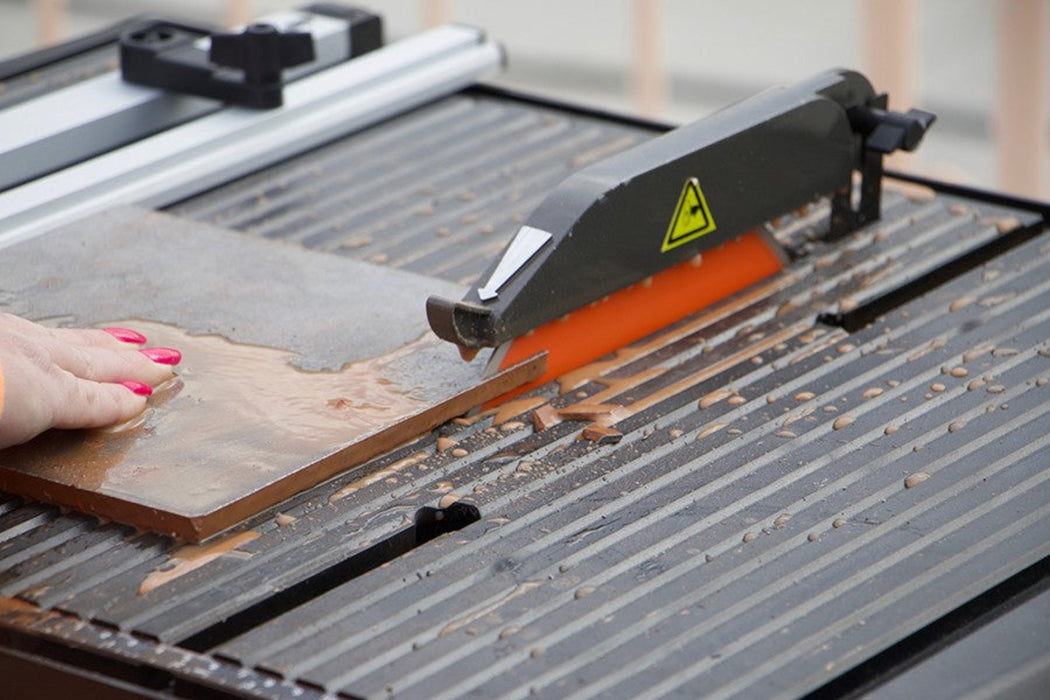 Close-up of Diamond Products CC912TS tile saw showing the cutting blade and sturdy frame for precise tile cutting.