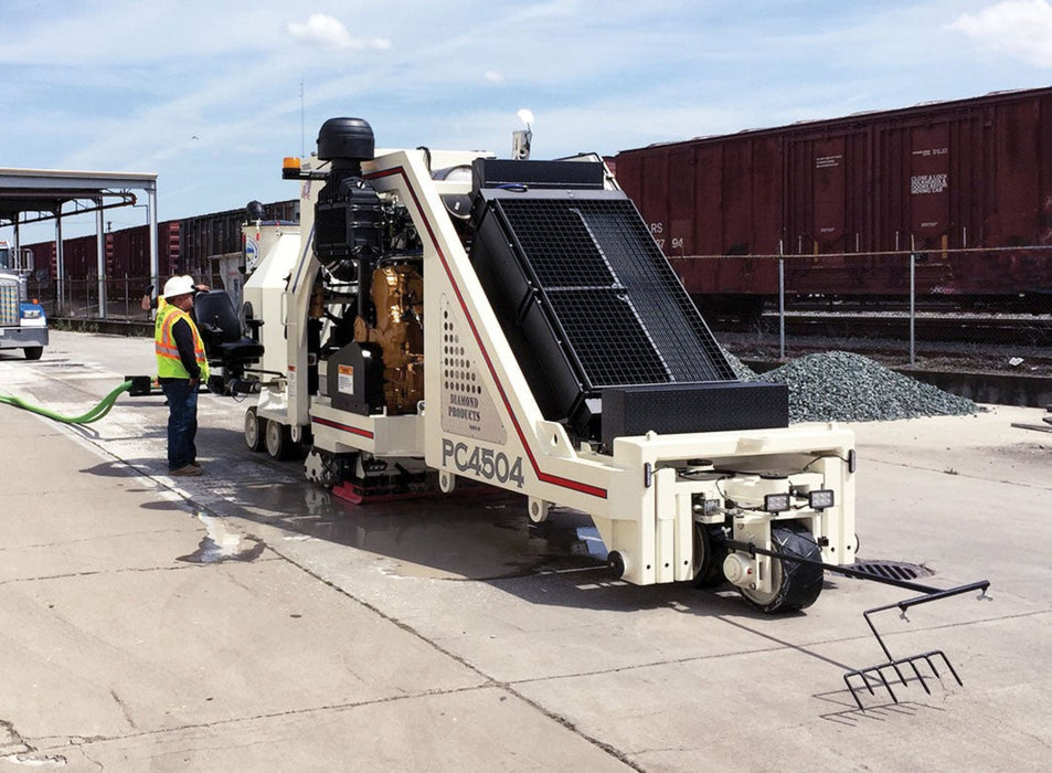 Diamond Products PC4504 pavement grinder for grinding and grooving concrete surfaces, with a sturdy metal body and abrasive grinding wheel.